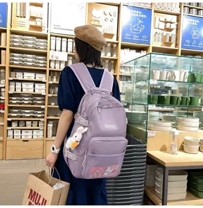 Zaino viola casual per studenti, borsa con simpatico ciondolo coniglietto e ampio spazio.