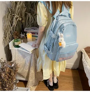 Zaino da scuola casual per studenti azzurro, borsa giornaliera minimalista con tasche.
