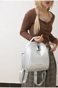Silver metallic dome backpack for women, multi-use casual travel shoulder bag detail view.
