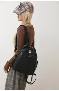 Detail view of the elegant black shell backpack showcasing fine leather texture and design.