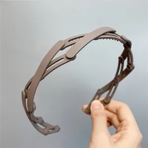 Brown foldable mesh headband detail view, portable plastic hair hoop for convenient daily styling use.