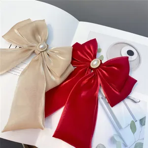 Elegant Lolita style double bow hair clips with pearls and rhinestones, long ribbon design.