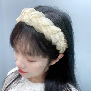 Close-up detail of organza rhinestone braided headband, showing hair accessory texture.