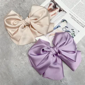 Large satin bow hair clip in champagne and purple, elegant French style spring hair accessory.