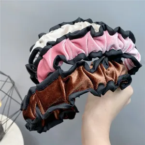 Velvet ruffled headband detail showcasing multi-color pleated fabric design for autumn.