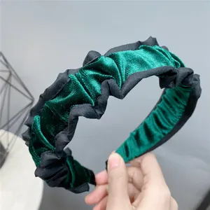 Green and black velvet headband with pleated ruffle design, perfect for autumn and winter.