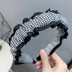 Houndstooth ruffle hair hoop detail view, stylish fabric headband for autumn and winter.