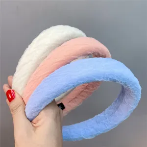 Detailed view of wide bubble gauze padded headbands in white, pink, and blue, soft fabric.
