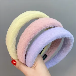 Detailed view of wide bubble gauze sponge headbands in pastel yellow, pink and purple colors.