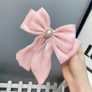 Pink lolita hair bow clip with pearl rhinestone center and long ribbons for sweet girls.