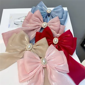 Elegant multi-layer bow hair clip with shiny fabric, pearl rhinestone center and long ribbons.