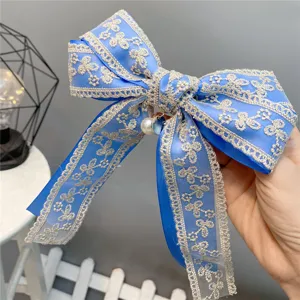 Blue double-layer lace bow hair clip with silver embroidery and sweet pearl pendant detail.