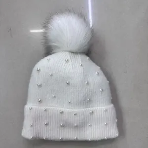 Pearl embellished knitted beanie hat detail with fluffy pom pom winter warm knit cap