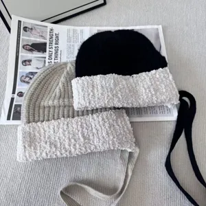 Womens knitted beanie hat with plush contrast and ear flap ties for autumn winter.