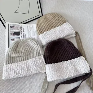 Knit plush splicing winter hat with cute earflap ties, warm Korean style design for women.