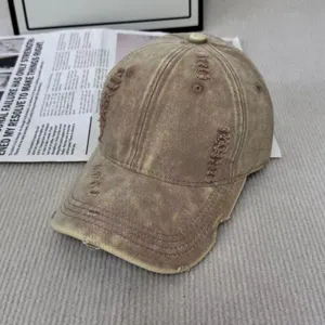 Vue détaillée de la casquette de baseball vintage usée en coton marron au style rétro déchiré.
