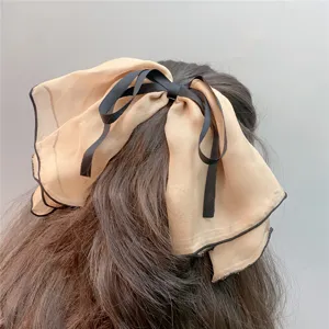 Oversized double-layer chiffon bow hair clip with lettuce edge, elegant hair accessory for women.