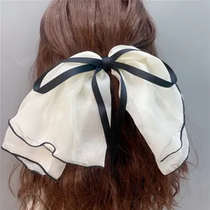 Large double layer bow hairpin chiffon hair clip, sweet style, detailed close-up shot.