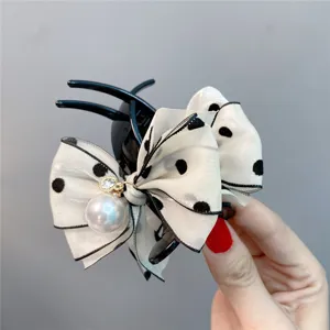 Sweet polka dot bow hair claw clip with faux pearl charm for stylish daily hair styling.