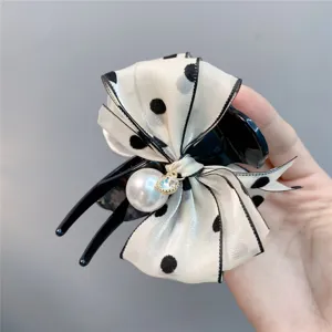 Sweet polka dot bow hair claw clip with large pearl and rhinestone detail for elegant hairstyles.