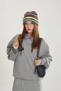 Colorful striped knit beanie with a small letter label, stylish and cozy winter cold hat.