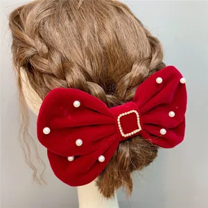Red velvet bow hair clip with pearls and sparkling rhinestone buckle for bridal and wedding wear.