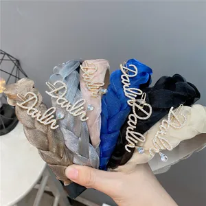 Detailed view of braided rhinestone letter hairbands, stylish multi-color mesh headbands.