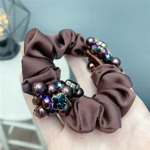 Brown satin hair scrunchie with faux pearls and dark crystal flower beads for women's daily wear.