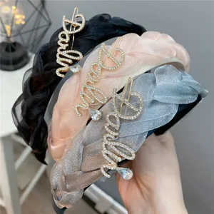 Detailed view of braided rhinestone headbands, stylish mesh fabric hair accessory for women.