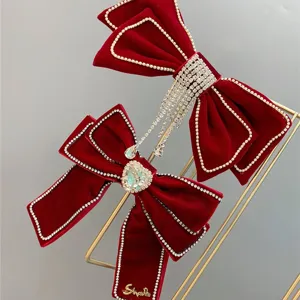 Red velvet bow hair clip with rhinestones, elegant bridal hair accessory for wedding party.