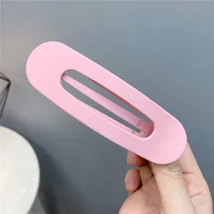 Pink acrylic hollow hair claw clip for women, large geometric hair accessory for daily styling wash makeup.