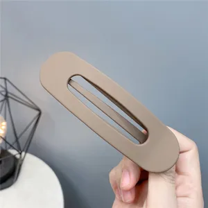 Close-up view of a minimalist hollow acrylic hair clip in khaki, ideal for daily styling.