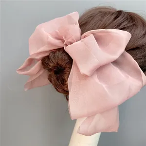 Oversized pink mesh bow hair clip for women, elegant three-layer hair barrette accessory.