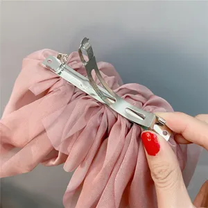 Korean style oversized pink mesh bow hair clip with three-layer draping spring clip design.