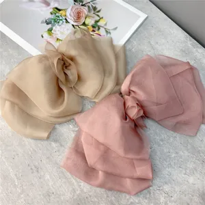 Oversized mesh bow hair clip detail shot, showing the 3-layer draping organza design.