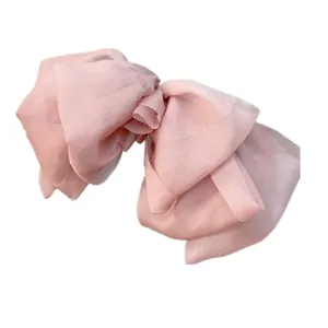 Oversized pink mesh hair bow clip, three-layer draped design, sweet vintage hair accessory.