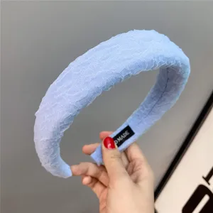 Close-up view of the light blue bubble gauze padded headband, showing soft texture and wide brim.