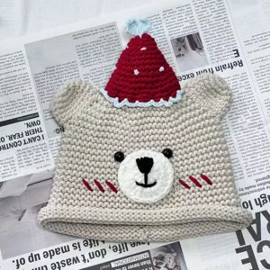 Handmade crochet bear beanie hat detail, cute winter knit cap with red hat and heart accent.