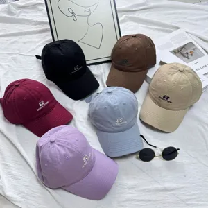 Classic washed cotton baseball cap for men and women, stylish letter embroidery design.