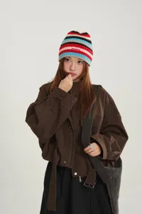 Detailed view of the Korean niche colorful striped knit beanie with small patch, stylish winter warm hat.