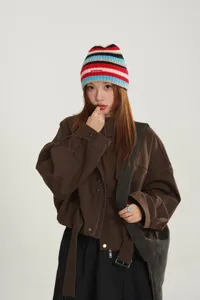 Colorful striped knit beanie hat featuring a small letter patch, perfect for autumn and winter.