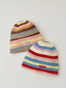 Colorful striped knit beanie hat detail view, soft autumn winter warm wool hat close up.