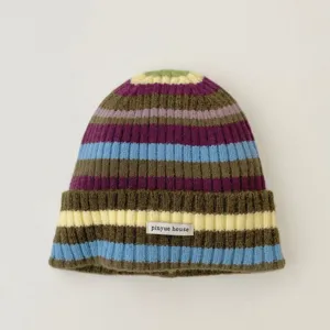 Detailed view of colorful striped knit beanie featuring a small fabric letter patch.