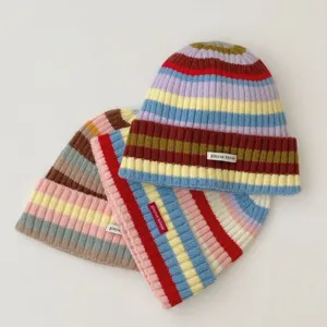 Colorful striped knitted beanie hat, warm winter wool cap, stylish indie streetwear style.