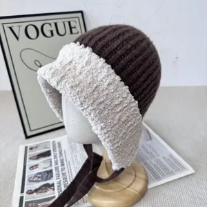 Knit plush spliced earflap hat details showing cozy texture and warm tie design.