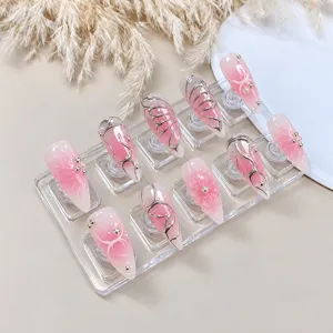 Handmade press-on nails detail, pink gradient long pointed fake nails with silver 3d butterfly design