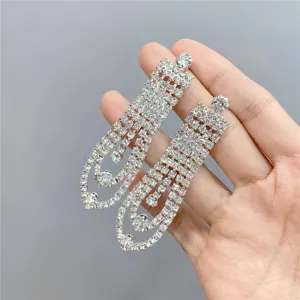 Long rhinestone tassel earrings featuring multi-strand sparkling crystal design for women.