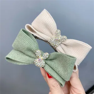 Close-up detail of knitted bow hair clip with crystal bunny design for daily wear details.