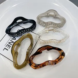 Detail view of stylish acrylic cloud-shaped hair claw clips in assorted jelly and leopard print colors.