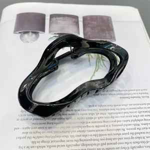 Black glossy acrylic hollow cloud hair claw clip, elegant large hair accessory for women.
